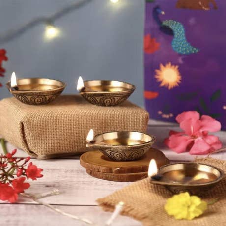 Radiant Diya Set. A gift set of four handcrafted antique brass diyas. Traditional oil lamps for Diwali, Navratri and other festivals.