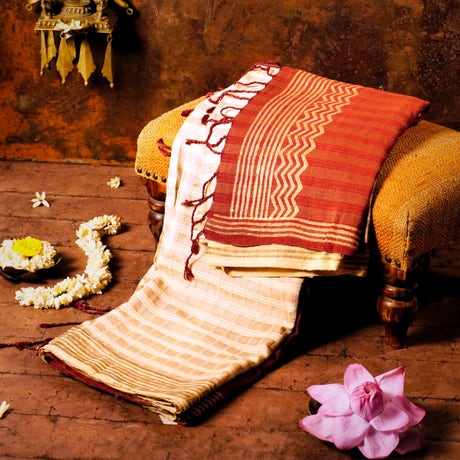 Cream and Orange Red Silk Energized Saree with rich golden zari work