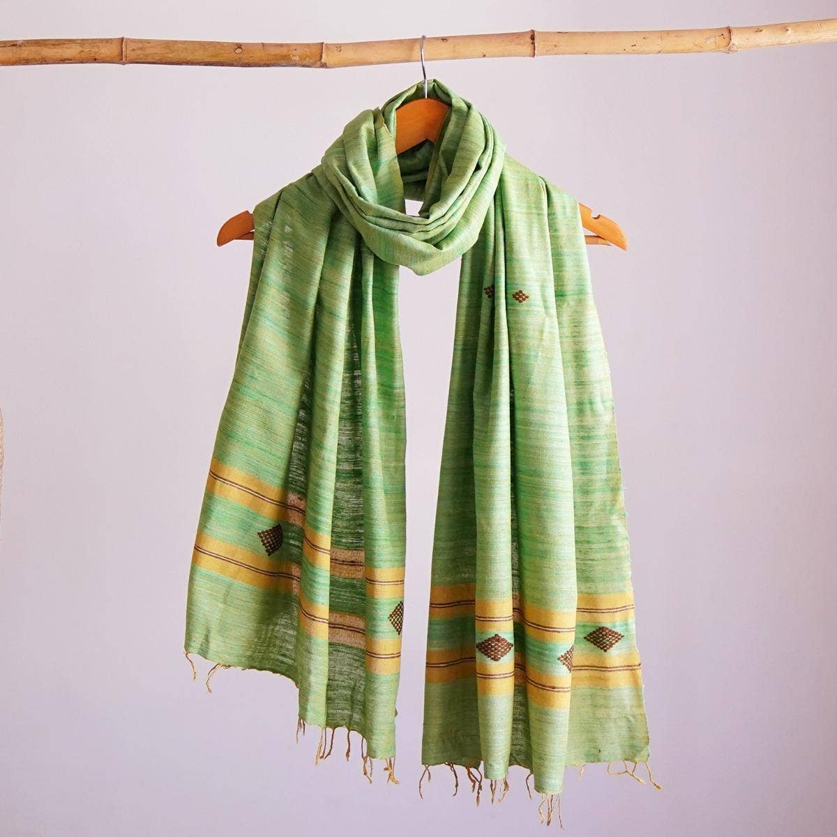 Naturally dyed handwoven pista-coloured eri silk stole showcasing a harmonious blend of traditional and contemporary design