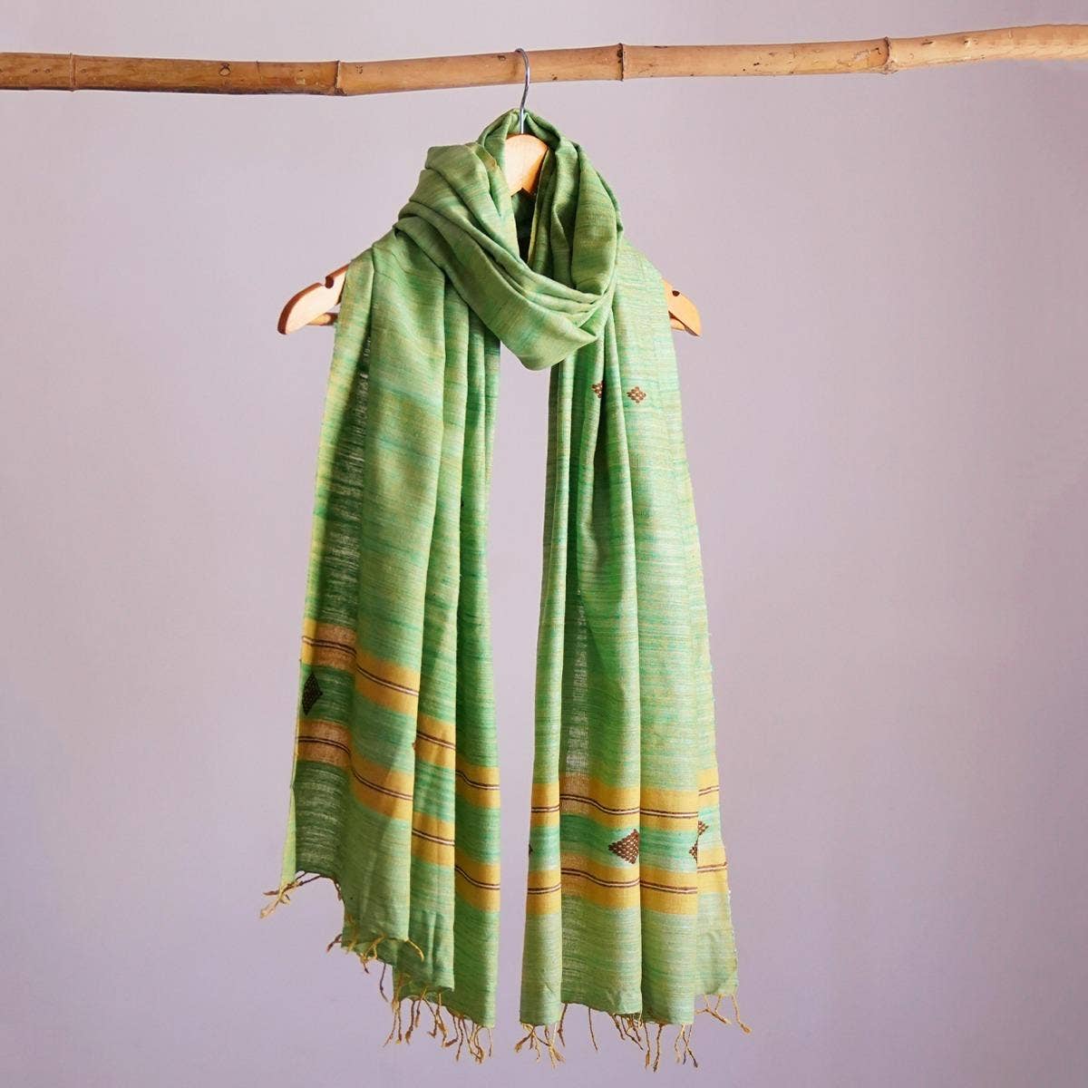 Naturally dyed handwoven pista-coloured eri silk stole showcasing a harmonious blend of traditional and contemporary design