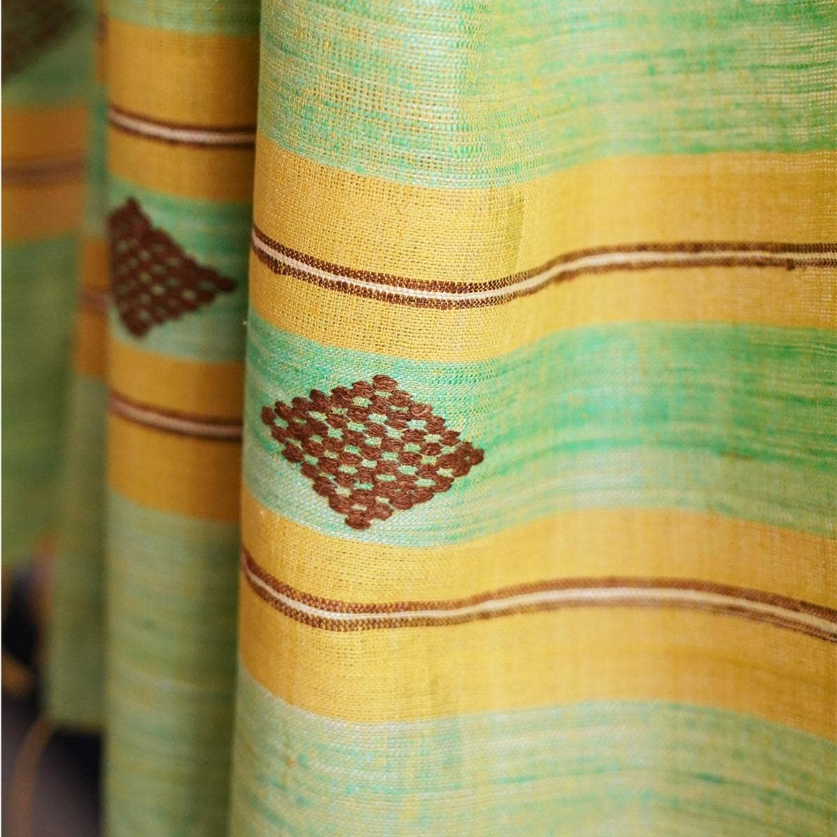 Naturally dyed handwoven pista-coloured eri silk stole showcasing a harmonious blend of traditional and contemporary design