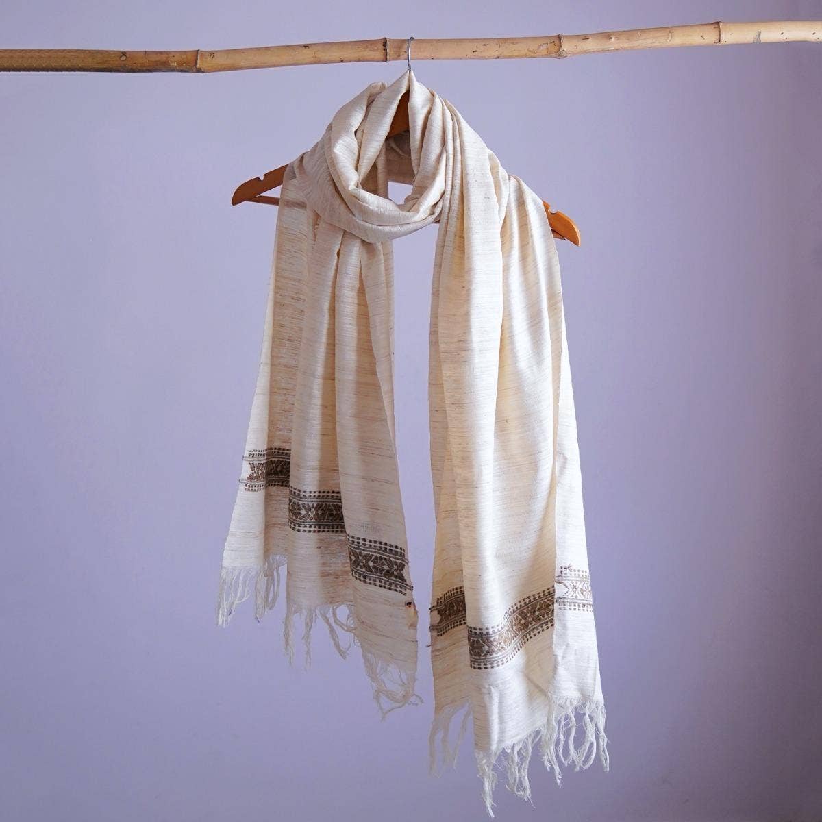 Chic off-white eri silk stole, naturally dyed with tea leaves, showcasing an intricately designed traditional pattern band