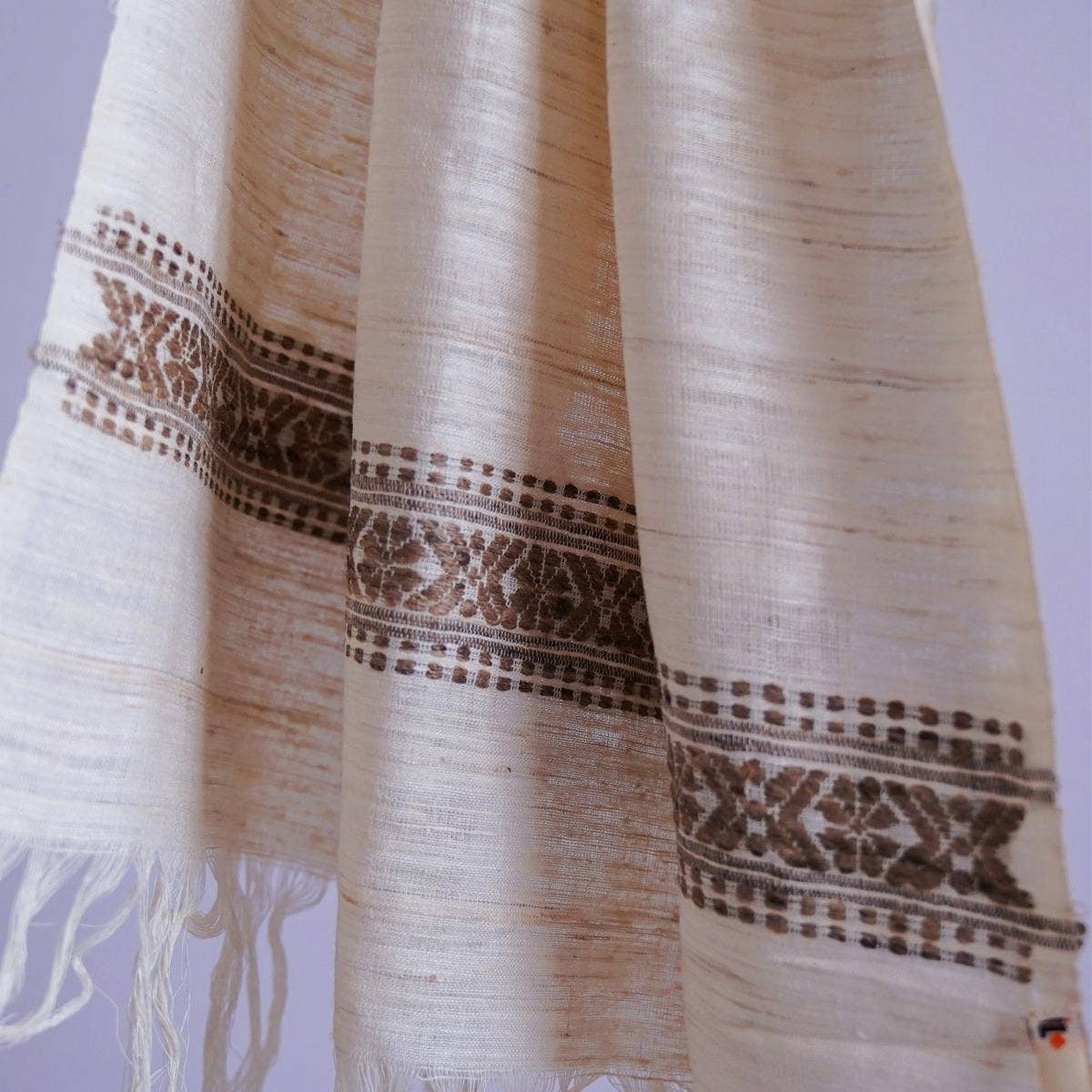 Chic off-white eri silk stole, naturally dyed with tea leaves, showcasing an intricately designed traditional pattern band